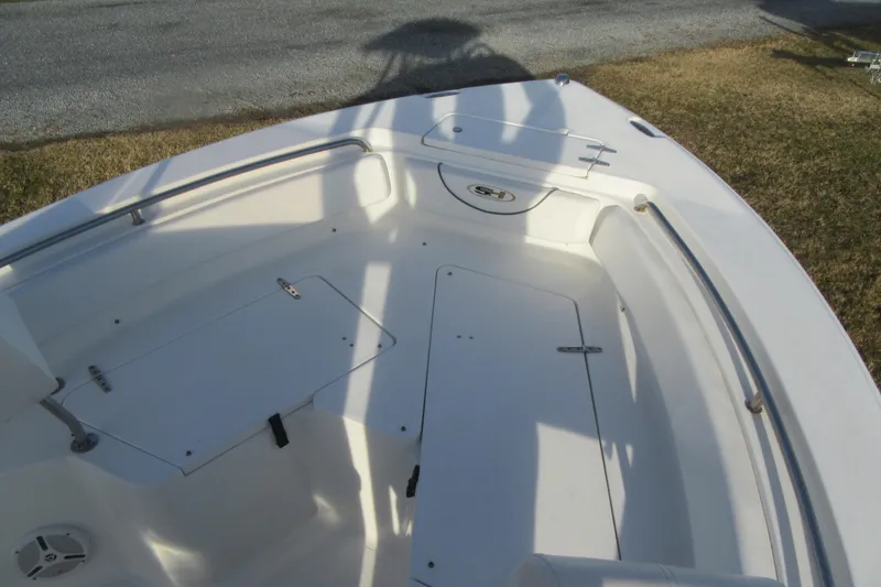 Slide: The Image of 2014 Sea Hunt Ultra 234 boat interior with storage compartments and seating. - 8