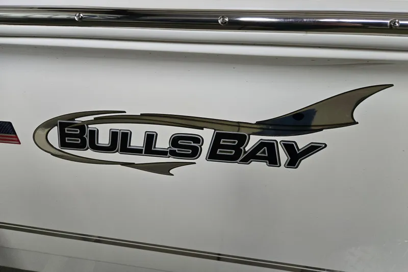 Slide: The Image of 2026 Bulls Bay 2000 boat logo on white surface with American flag detail. - 13