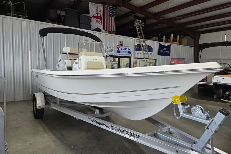 Slide: The Image of 2026 Bulls Bay 2000 boat on trailer in showroom, featuring sleek white design. - 2