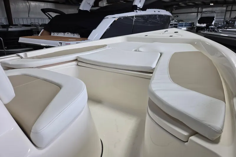 Slide: The Image of 2026 Bulls Bay 2000 boat interior with cushioned seating in a showroom. - 6
