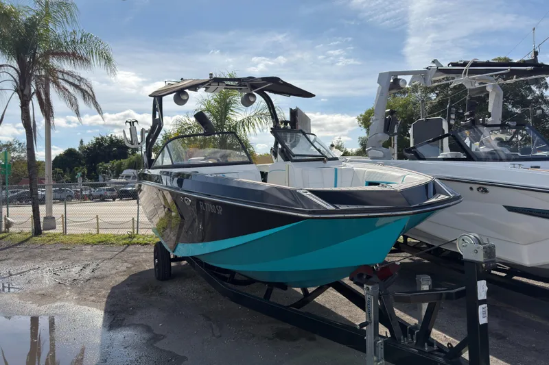 The Image of 2018 Nautique Super Air Nautique G25 Coastal Edition boat on trailer, parked outdoors. - 0