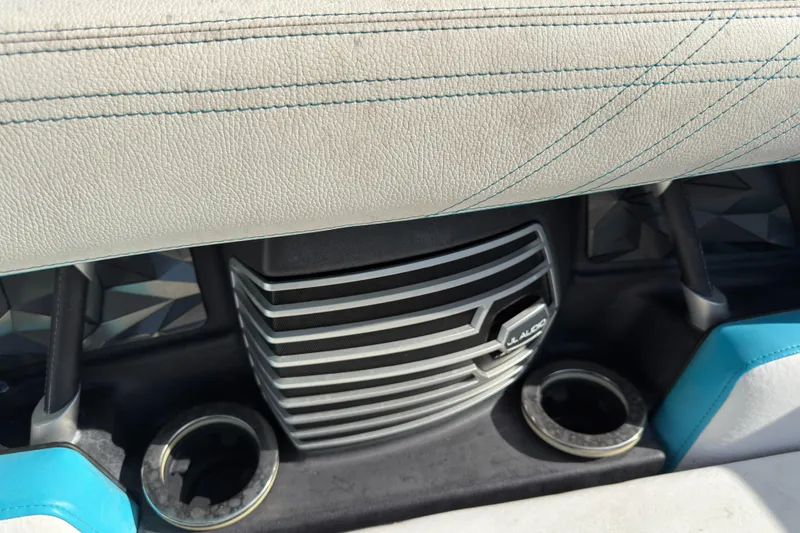 Slide: The Image of 2018 Nautique Super Air Nautique G25 Coastal Edition interior with JL Audio speaker and cup holders. - 13