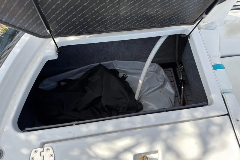 Slide: The Image of Open storage compartment of 2018 Nautique Super Air Nautique G25 Coastal Edition boat. - 14