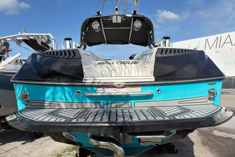 Slide: The Image of 2018 Nautique Super Air Nautique G25 Coastal Edition, rear view, vibrant blue and black design. - 5