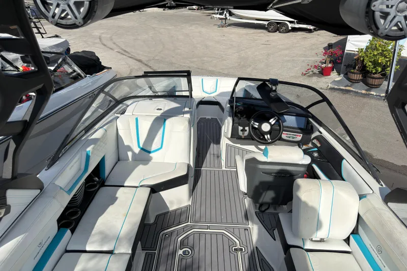 Slide: The Image of 2018 Nautique Super Air Nautique G25 Coastal Edition interior with white and blue seating. - 6
