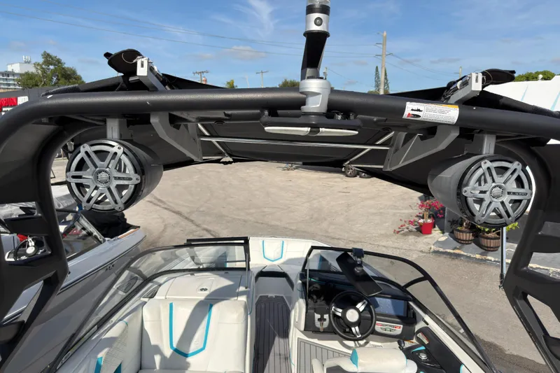 Slide: The Image of 2018 Nautique Super Air Nautique G25 Coastal Edition interior with speakers and steering wheel. - 7