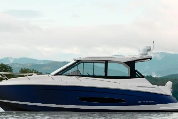 The Image of 2026 Regal 36 Grande Coupe yacht on serene water with mountain backdrop. - 0