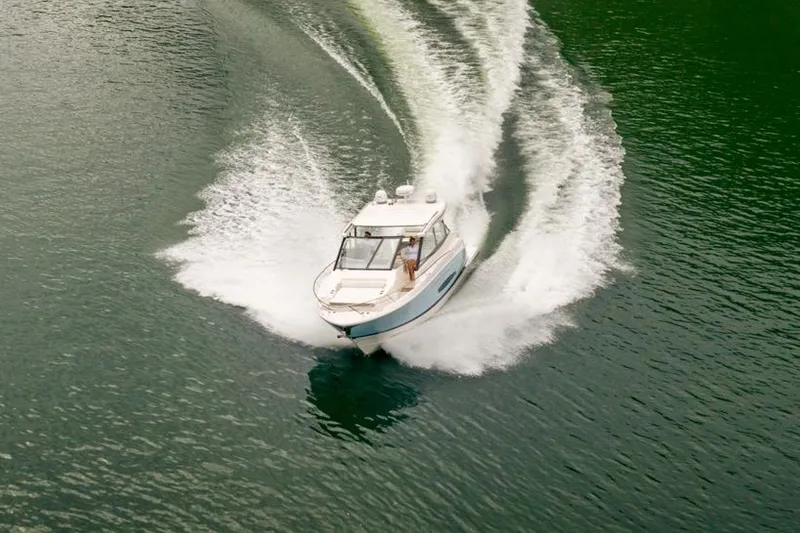 Slide: The Image of Manufacturer Provided Image: 2026 Regal 36 Grande Coupe cruising on open water, creating dynamic waves. - 2