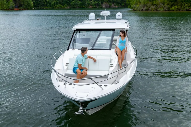 Slide: The Image of Manufacturer Provided Image: 2026 Regal 36 Grande Coupe cruising on a serene lake with two people onboard. - 5