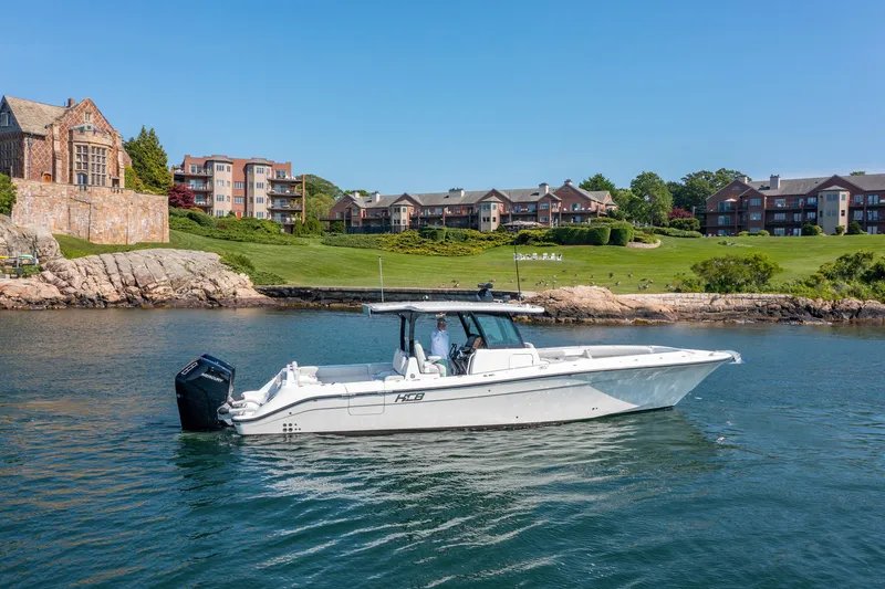 The Image of 2024 HCB 39 Speciale boat cruising near waterfront homes. - 1