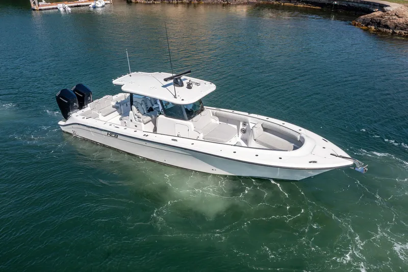 Slide: The Image of 2024 HCB 39 Speciale boat cruising on clear water. - 2