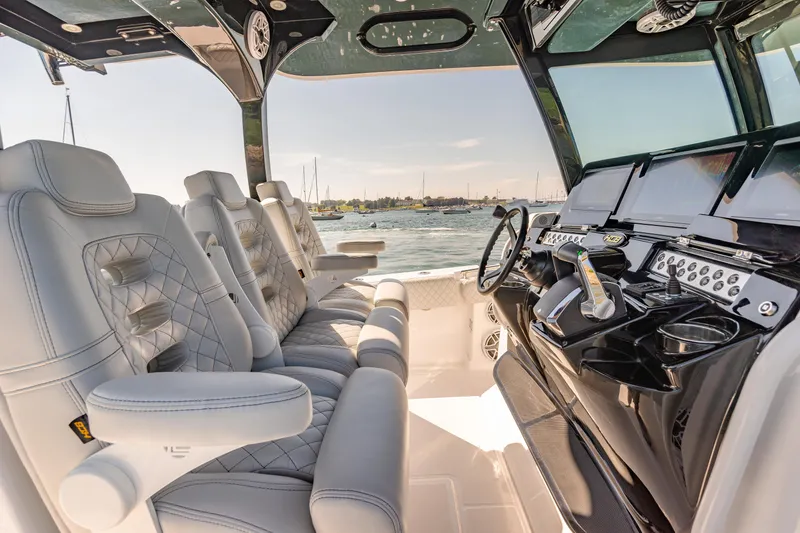 Slide: The Image of 2024 HCB 39 Speciale boat interior with luxurious seating and advanced dashboard. - 26