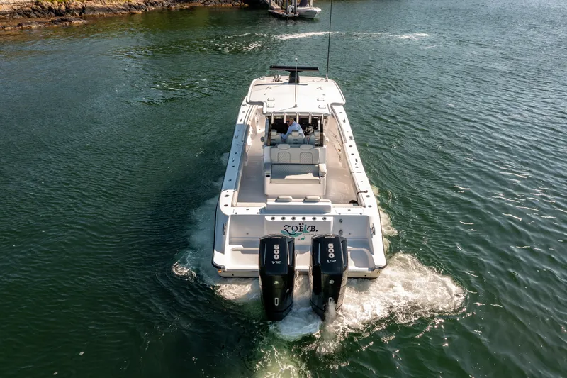 Slide: The Image of 2024 HCB 39 Speciale boat cruising on water with twin outboard engines. - 9