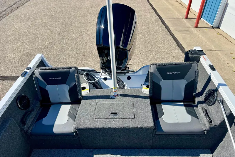 Slide: The Image of 2024 Crestliner 1650 Fish Hawk SC boat interior with dual seats and motor. - 13