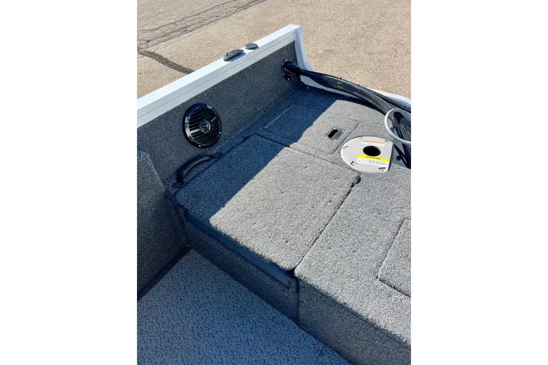 Slide: The Image of 2024 Crestliner 1650 Fish Hawk SC interior with carpeted deck and speaker. - 17