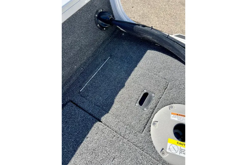 Slide: The Image of 2024 Crestliner 1650 Fish Hawk SC boat interior with carpeted flooring and storage compartment. - 22