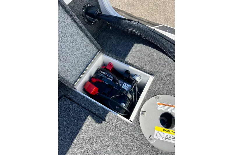 Slide: The Image of 2024 Crestliner 1650 Fish Hawk SC boat battery compartment with Duracell battery. - 23