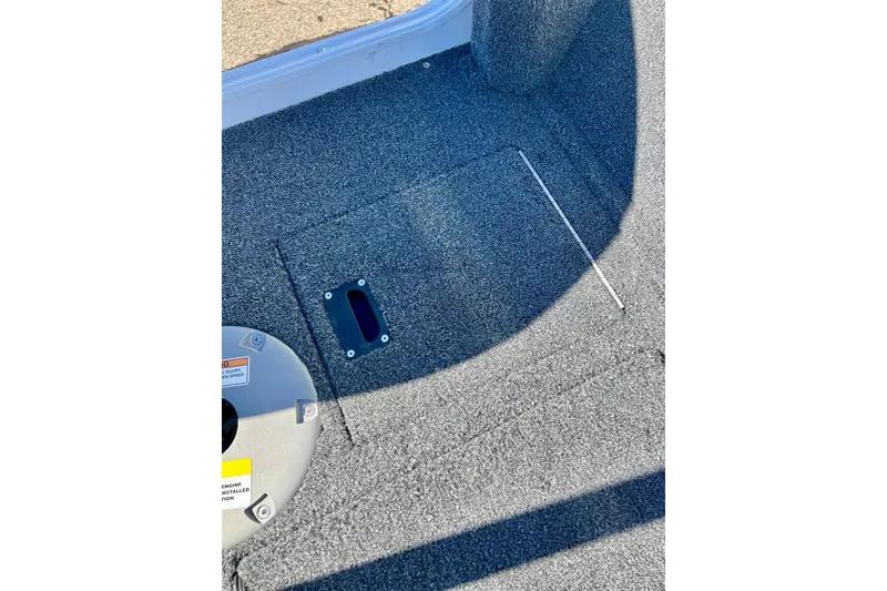 Slide: The Image of 2024 Crestliner 1650 Fish Hawk SC boat interior with carpeted flooring and storage compartment. - 25