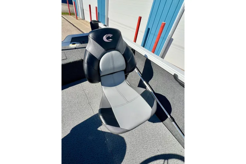 Slide: The Image of 2024 Crestliner 1650 Fish Hawk SC boat seat, black and gray design, outdoor setting. - 27
