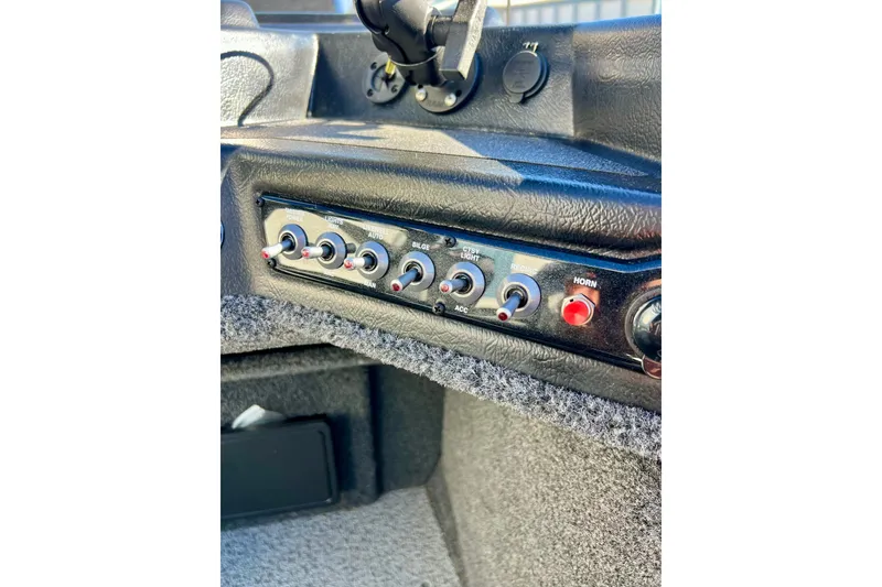 Slide: The Image of 2024 Crestliner 1650 Fish Hawk SC dashboard with control switches and horn button. - 33