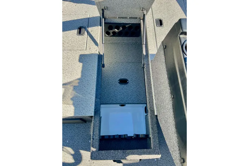 Slide: The Image of 2024 Crestliner 1650 Fish Hawk SC storage compartment with rod holders and organized interior. - 38
