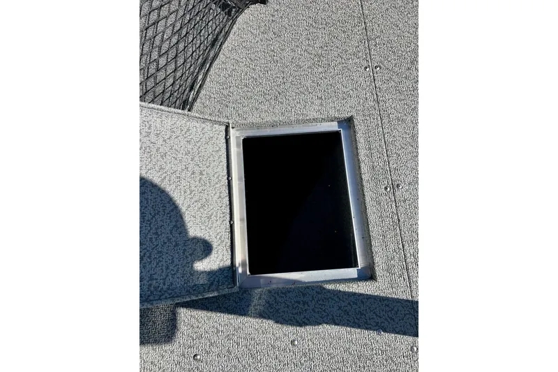 Slide: The Image of 2024 Crestliner 1650 Fish Hawk SC boat deck with open storage compartment. - 44