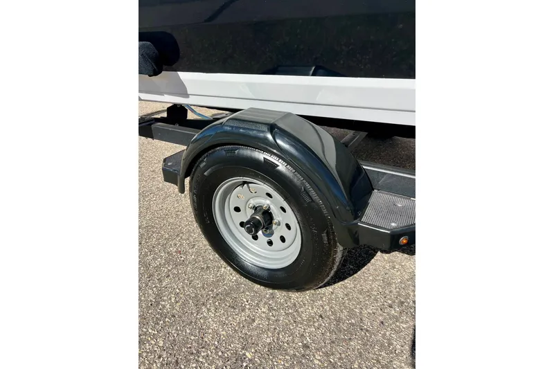 Slide: The Image of 2024 Crestliner 1650 Fish Hawk SC trailer wheel on pavement. - 5