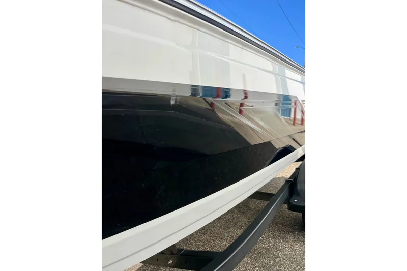 Slide: The Image of 2024 Crestliner 1650 Fish Hawk SC boat side view, showcasing sleek design and glossy finish. - 59