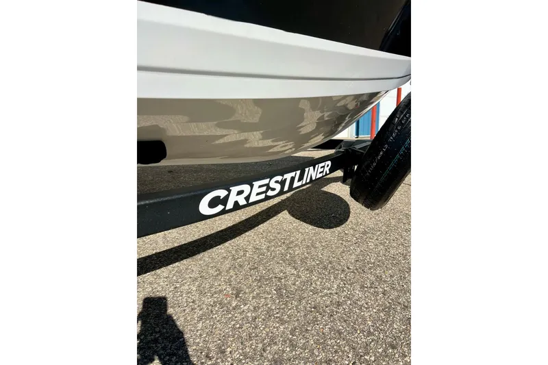Slide: The Image of 2024 Crestliner 1650 Fish Hawk SC boat trailer close-up on pavement. - 6
