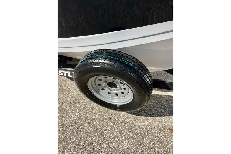 Slide: The Image of 2024 Crestliner 1650 Fish Hawk SC trailer tire on pavement. - 7