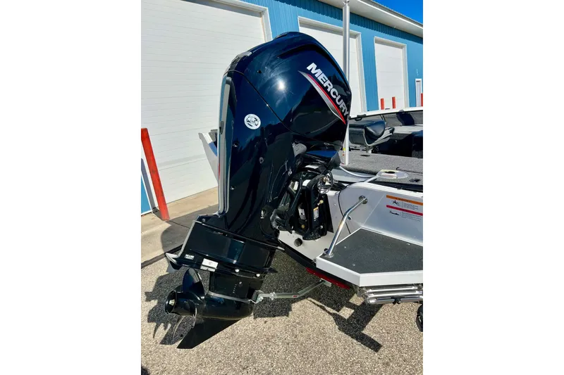 Slide: The Image of 2024 Crestliner 1650 Fish Hawk SC with Mercury outboard motor, parked outdoors. - 9