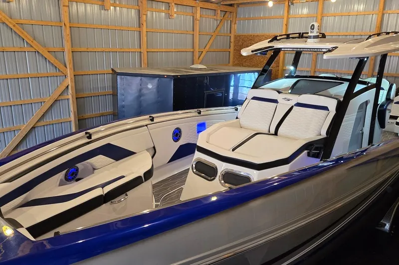 Slide: The Image of 2021 Sunsation 34 CCX boat with sleek design in a storage facility. - 11