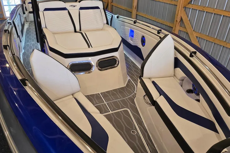 Slide: The Image of 2021 Sunsation 34 CCX boat interior with white and blue seating, modern design. - 12