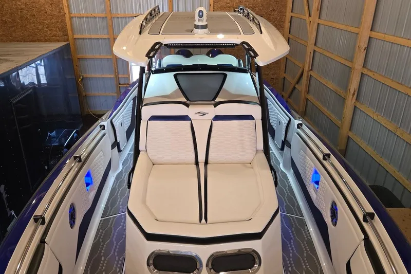 Slide: The Image of 2021 Sunsation 34 CCX boat interior with luxurious seating in a storage facility. - 13