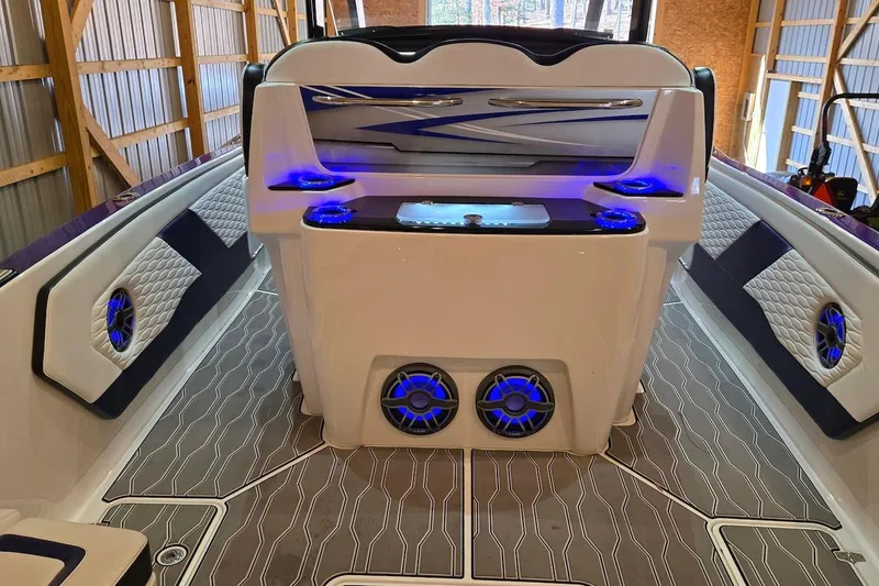Slide: The Image of 2021 Sunsation 34 CCX boat interior with blue LED lighting and modern design. - 16