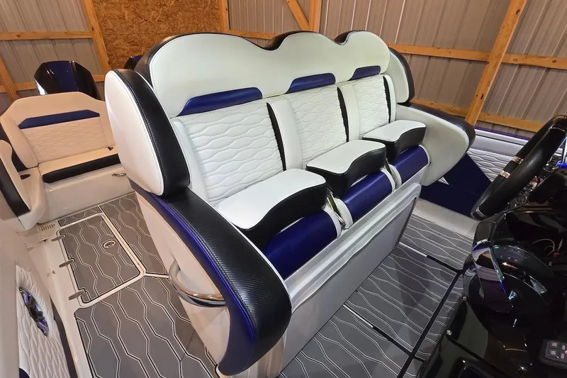Slide: The Image of 2021 Sunsation 34 CCX boat interior with luxurious white and blue seating. - 18
