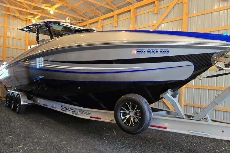Slide: The Image of 2021 Sunsation 34 CCX boat on trailer in a wooden storage facility. - 26