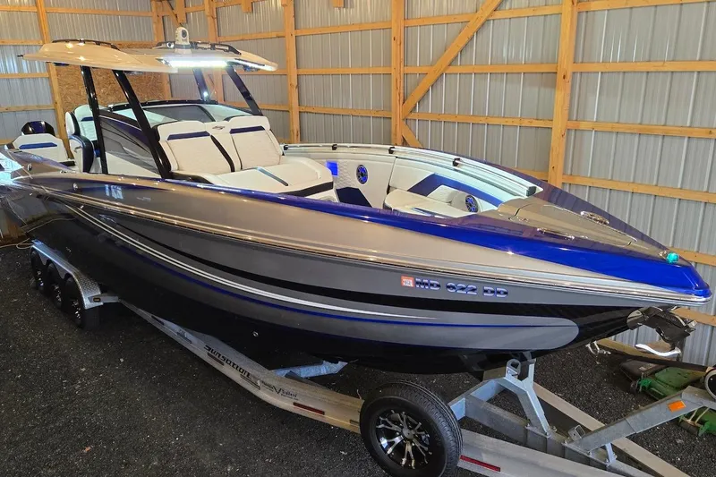 Slide: The Image of 2021 Sunsation 34 CCX boat in a garage, featuring sleek design and modern amenities. - 28