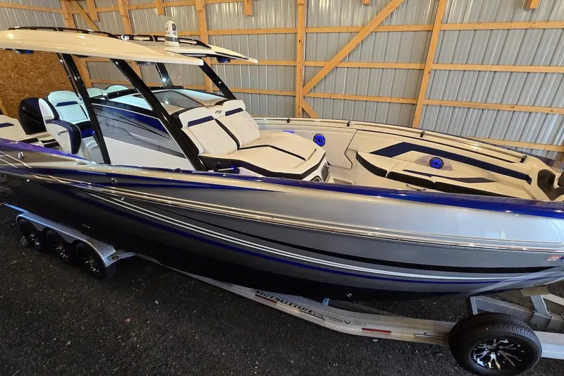 Slide: The Image of 2021 Sunsation 34 CCX boat in a garage, showcasing sleek design and modern features. - 29