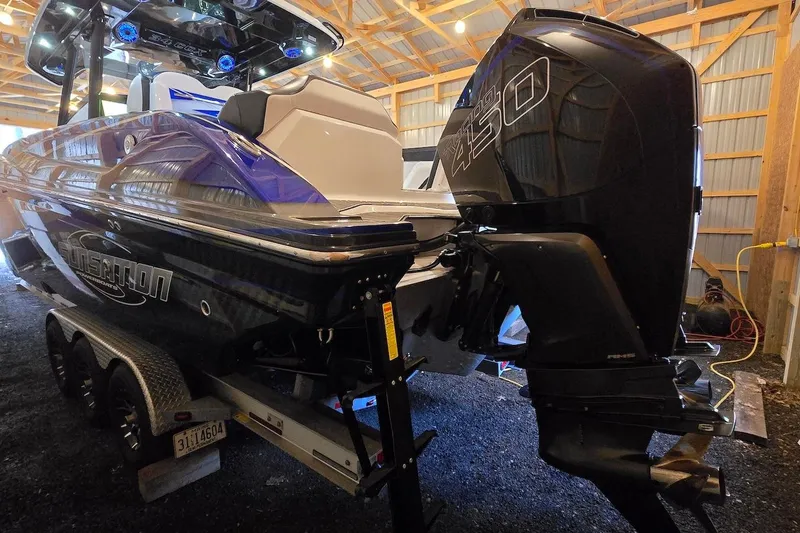 Slide: The Image of 2021 Sunsation 34 CCX boat with powerful outboard engine in a wooden storage facility. - 31