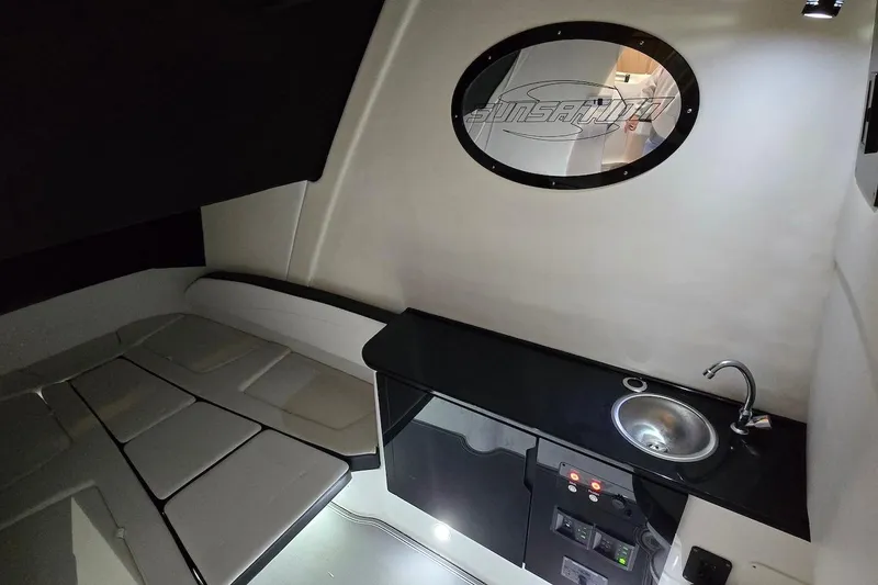 Slide: The Image of Interior of 2021 Sunsation 34 CCX boat with kitchenette and seating area. - 34