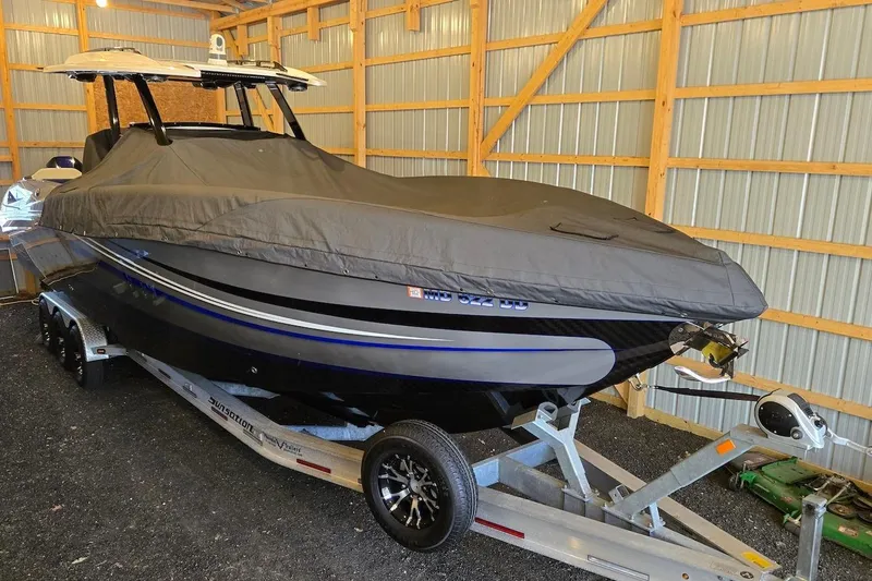 Slide: The Image of 2021 Sunsation 34 CCX boat covered in storage on a trailer. - 37