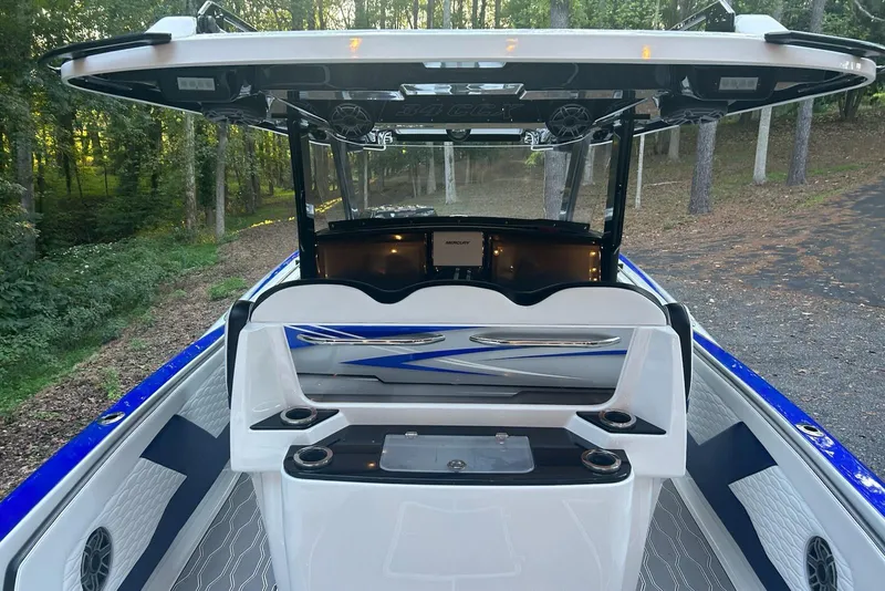 Slide: The Image of 2021 Sunsation 34 CCX boat interior with modern console and seating. - 6