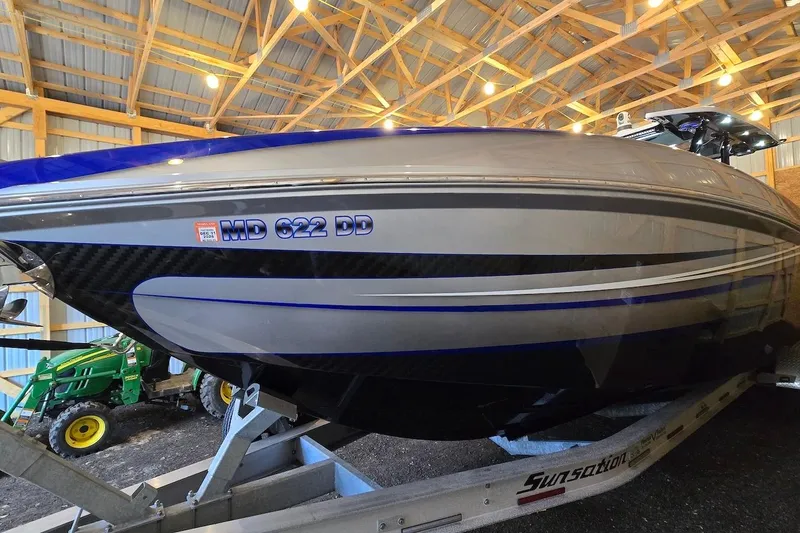 Slide: The Image of 2021 Sunsation 34 CCX boat on trailer in a wooden garage. - 7