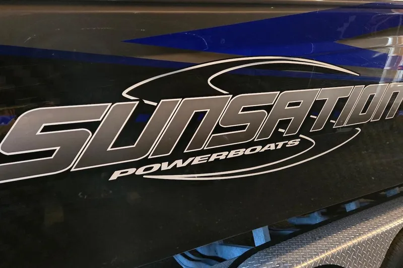 Slide: The Image of 2021 Sunsation 34 CCX powerboat logo on sleek black and blue surface. - 8