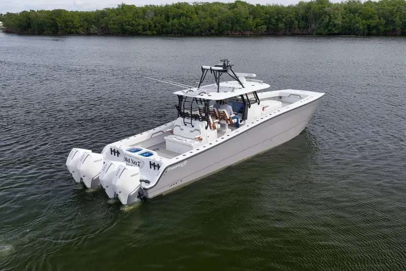 Slide: The Image of 2022 Freeman 42LR boat with quad engines on calm water. - 10