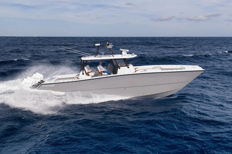 Slide: The Image of 2022 Freeman 42LR boat cruising on open ocean waters. - 16