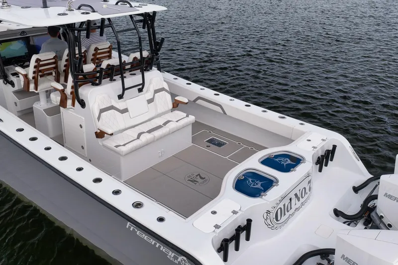 Slide: The Image of 2022 Freeman 42LR boat with spacious deck and seating on water. - 24
