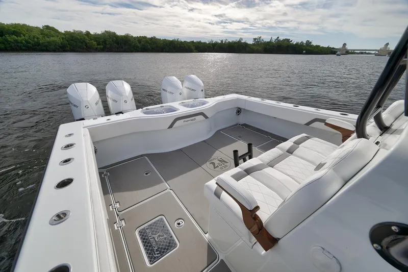 Slide: The Image of Luxurious 2022 Freeman 42LR boat with quad Mercury engines on a serene lake. - 28