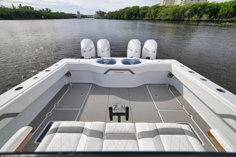 Slide: The Image of Freeman 42LR 2022 boat with quad engines on a serene river. - 30